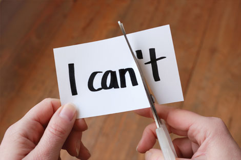 Sign reading 'I can't' being cut with scissors so that it reads 'I can'